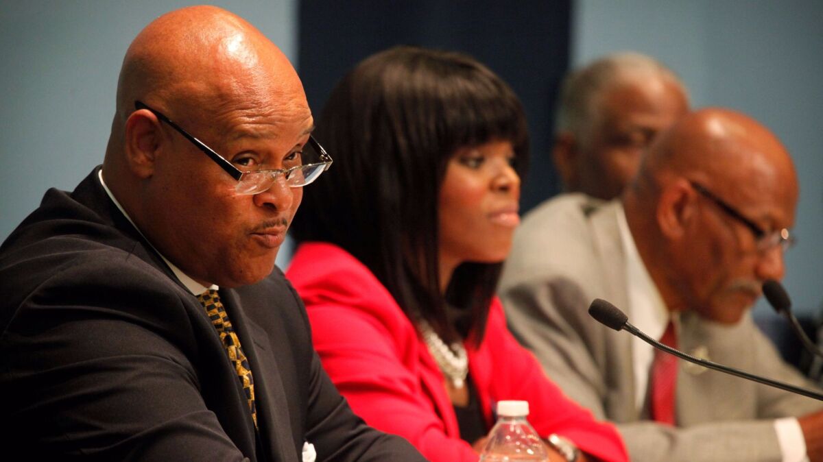 Omar Bradley and Aja Brown speak at a mayoral candidate forum in 2013. (Barbara Davidson / Los Angeles Times)
