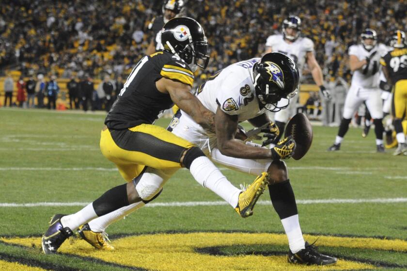 Baltimore Ravens wide receiver Torrey Smith (82) can't make a catch as Pittsburgh Steelers defensive back Antwon Blake (41) defends in the fourth quarter of an NFL football game on Sunday in Pittsburgh.