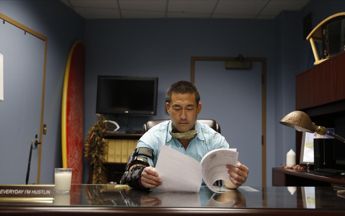 Derek Kawakami reads in his office in Lihue, Hawaii.