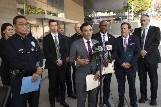 Los Angeles, CA - September 30 2024: United States Attorney Martin Estrada wit LAPDChief Dominic Choi, left, FBI Assistant Director in Charge Akil Davis, right, and other law enforcement officials outside the Los Angeles Federal Courthouse issued a statement on the sentencing of Jaime Tran, the former Riverside resident who pleaded guilty to federal hate crimes for shooting two Jewish men leaving synagogues in the Pico-Robertson district last year. (Al Seib / For the Los Angeles Times)