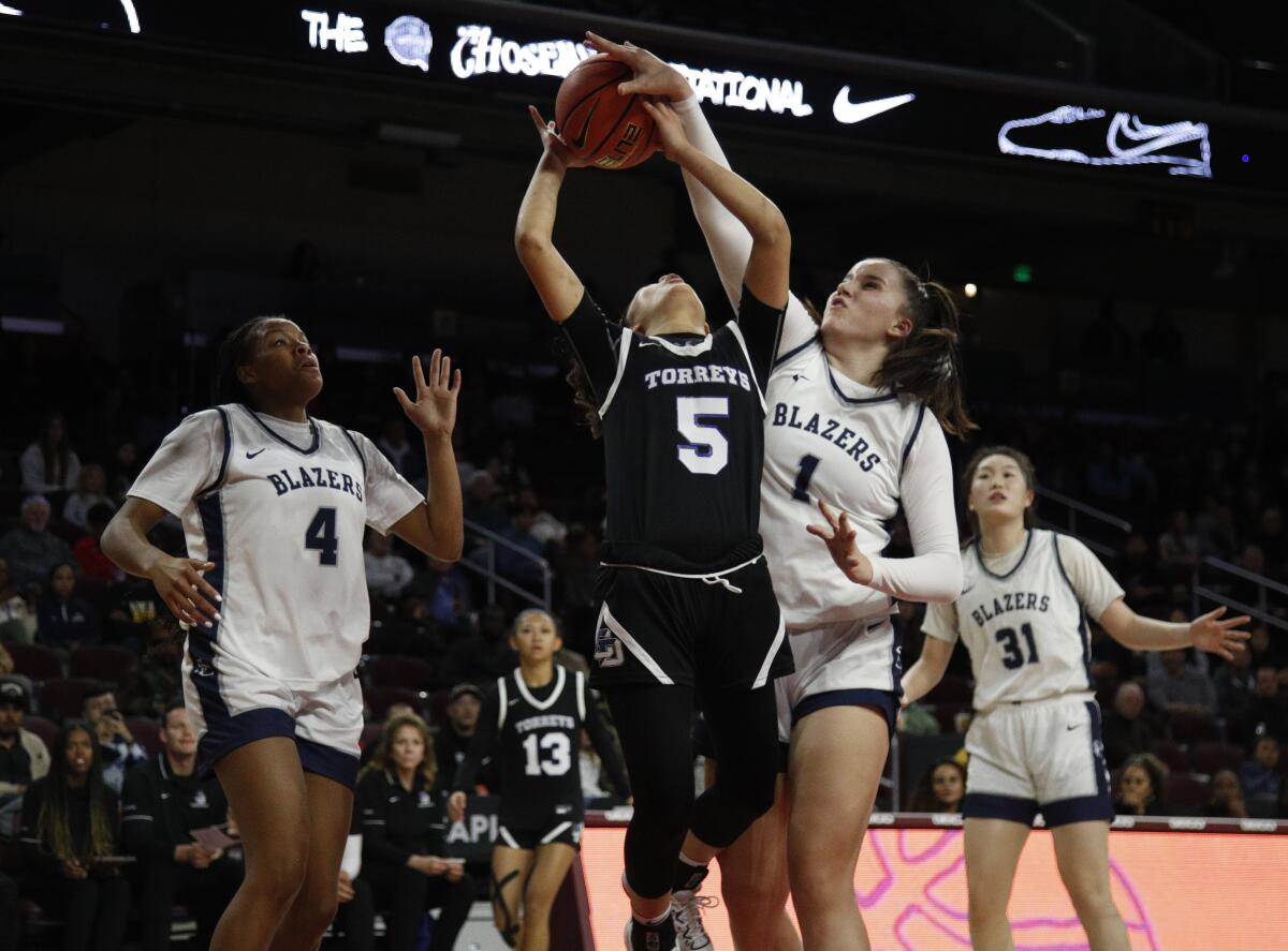 Sierra Canyon's Emilia Krstevski blocks a shot by La Jolla Country Day guard Sumayah Sugapong.