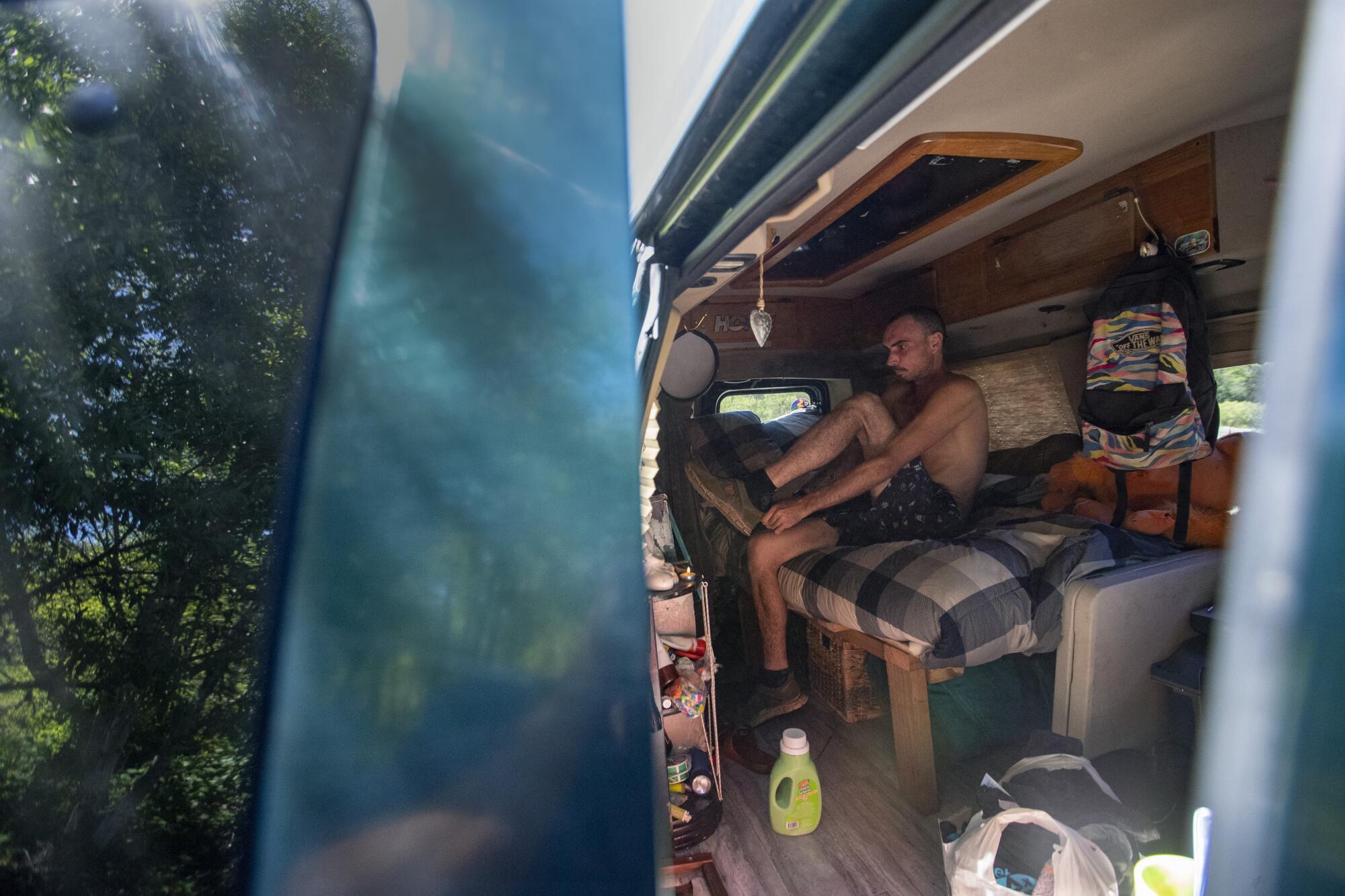 Cristiano gets dressed in his van.