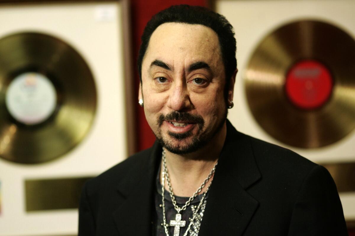 Music producer David Gest poses with some of his collection of entertainment memorabilia at a London auction house on Nov. 21, 2007.