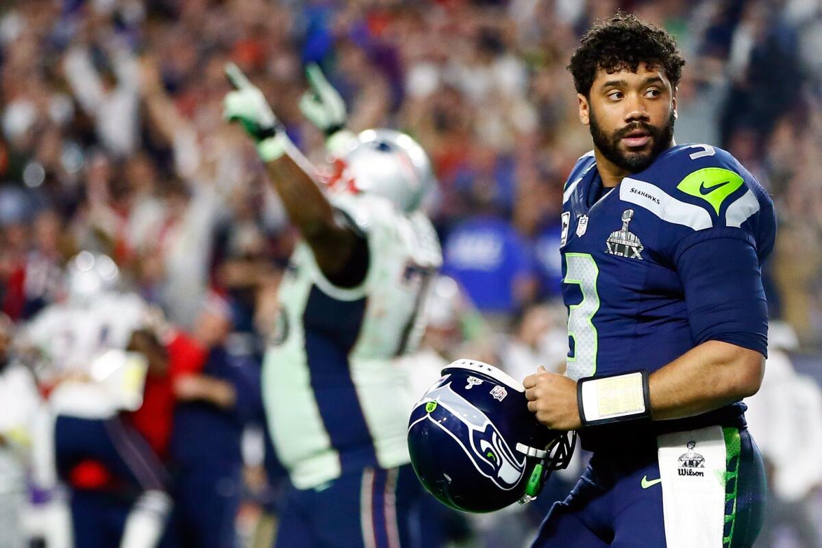Seattle quarterback Russell Wilson walks off the field after throwing an interception late in the fourth quarter of Super Bowl XLIX on Feb. 1.