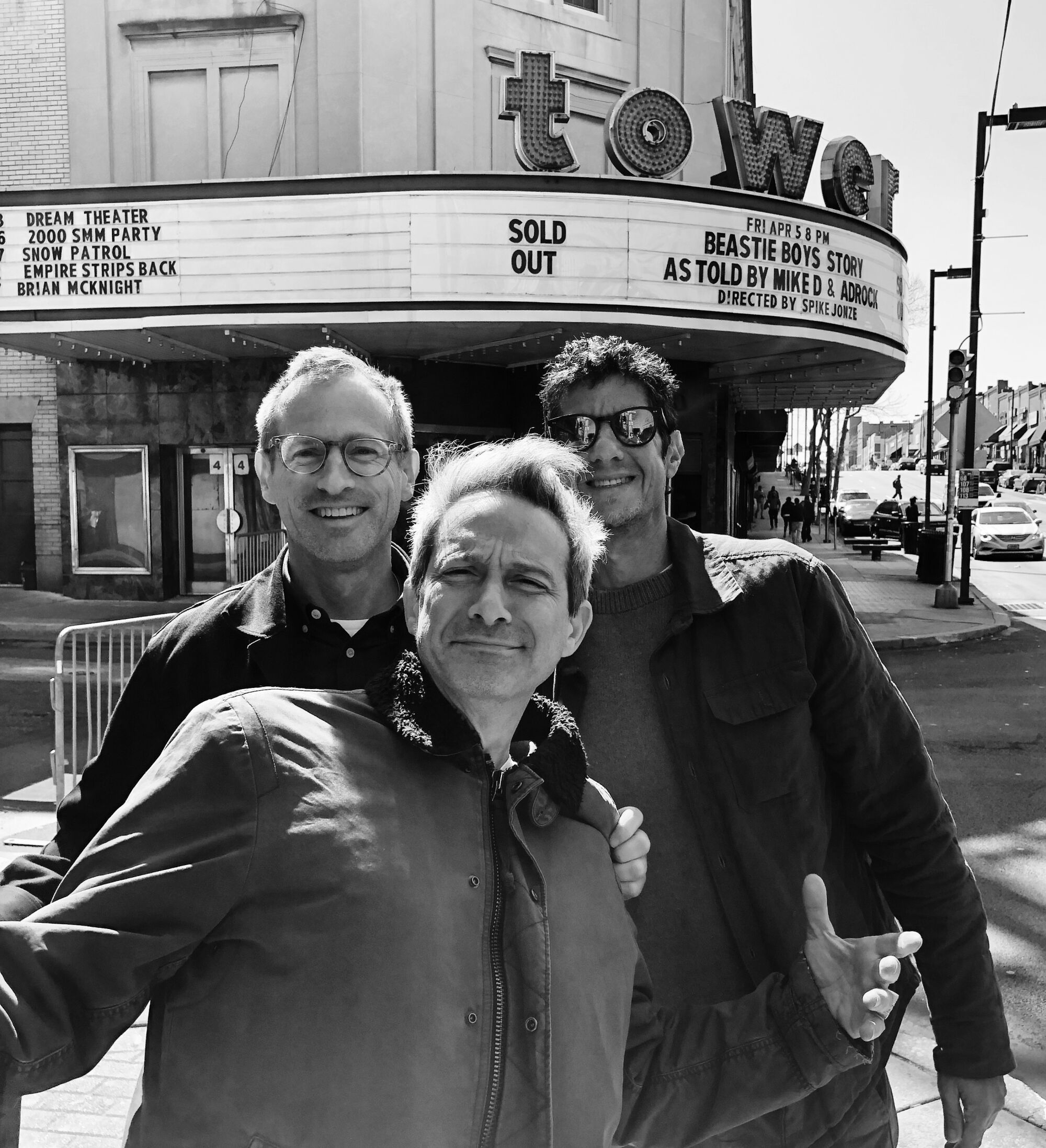Director Spike Jonze(left) with Adam Horovitz and Mike Diamond of the Beastie Boys mug for the camera in front of the Tower Theater in Philadelphia where part of "Beastie Boys Story" was filmed.