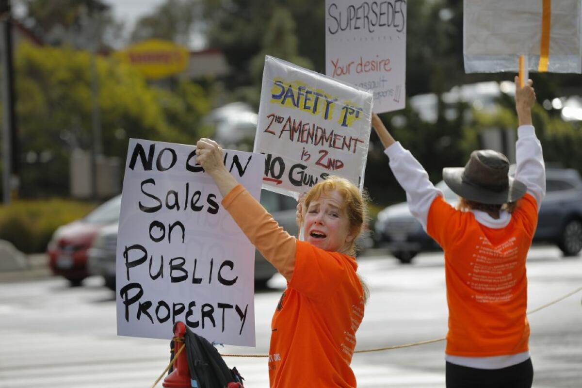 People from NeverAgainCA protest outside the Crossroads of the West gun show at Del Mar in 2018.