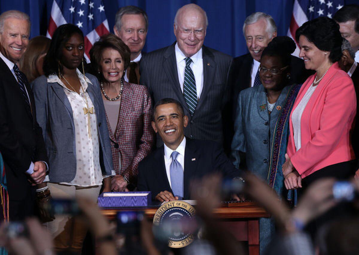 President Obama signs the Violence Against Women Act into law at the Department of the Interior in Washington.
