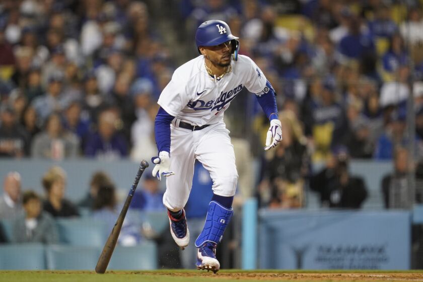 Los Angeles Dodgers' Mookie Betts runs to first during the fifth inning of a baseball game.