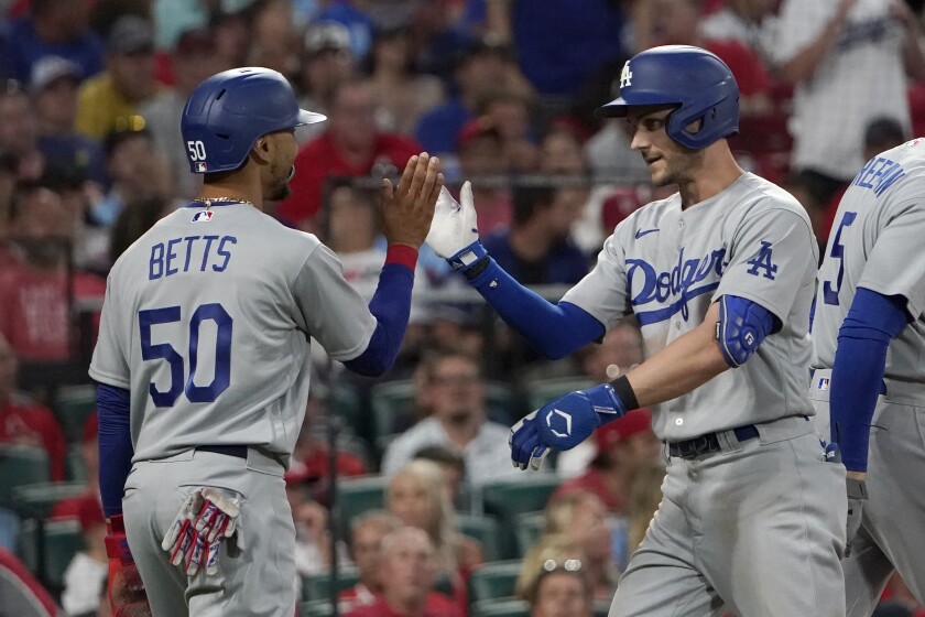 Dodgers' Trea Turner is congratulated by teammate Mookie Betts after hitting a double home run.