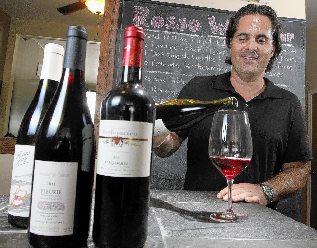 Rosso Wine Shop owner Jeff Zimmitti pours a glass of wine on Tuesday, July 23, 2014. The Glendale shop will have a wine tasting featuring these selected wines.