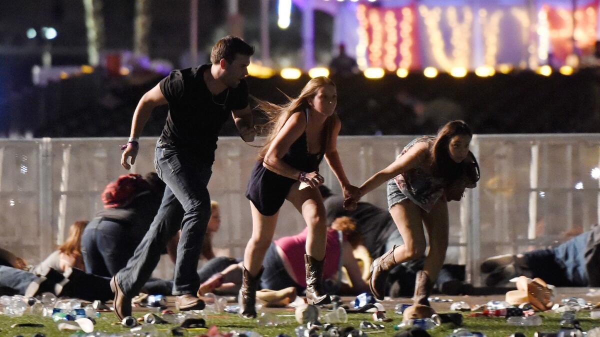 LAS VEGAS, NV - OCTOBER 01: (One of a 115-image Best of Year 2017 set) People run from the Route 91 Harvest country music festival after apparent gun fire was hear on October 1, 2017 in Las Vegas, Nevada. A gunman has opened fire on a music festival in Las Vegas, leaving at least 20 people dead and more than 100 injured. Police have confirmed that one suspect has been shot. The investigation is ongoing. (Photo by David Becker/Getty Images) ** OUTS - ELSENT, FPG, CM - OUTS * NM, PH, VA if sourced by CT, LA or MoD **