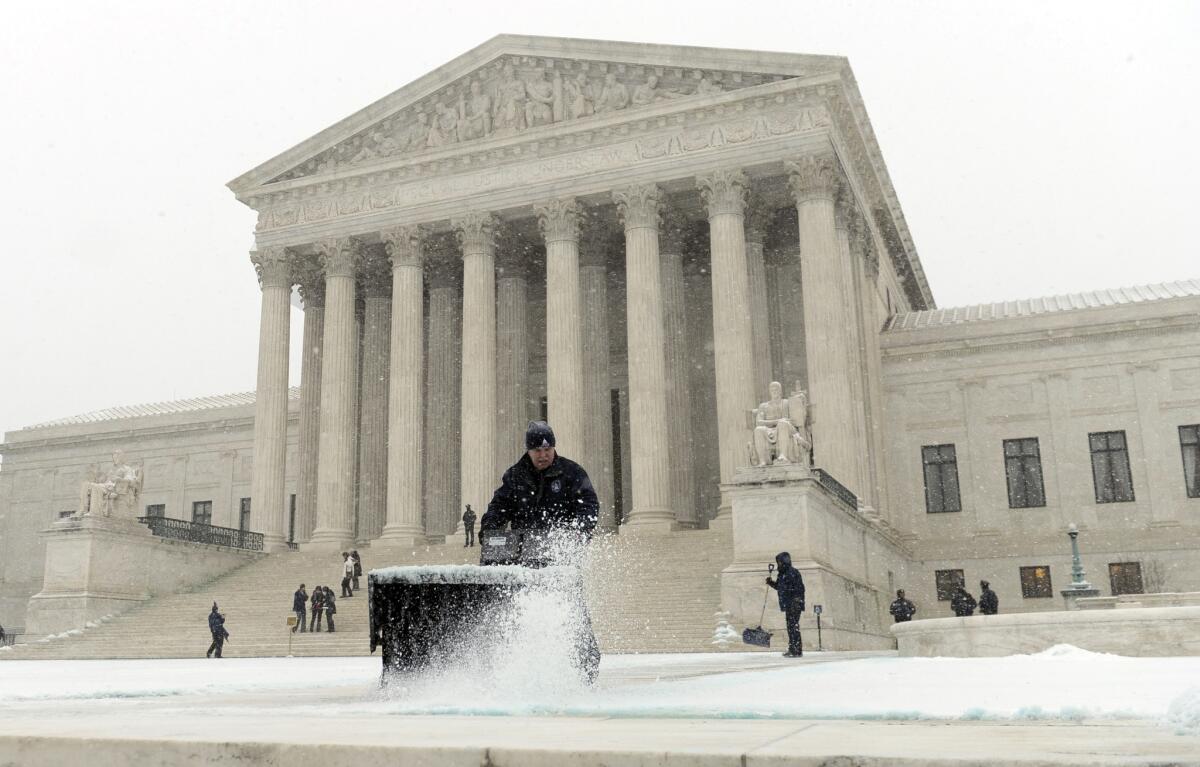 The steps of the Supreme Court are cleared during the start of a major snowstorm in Washington.