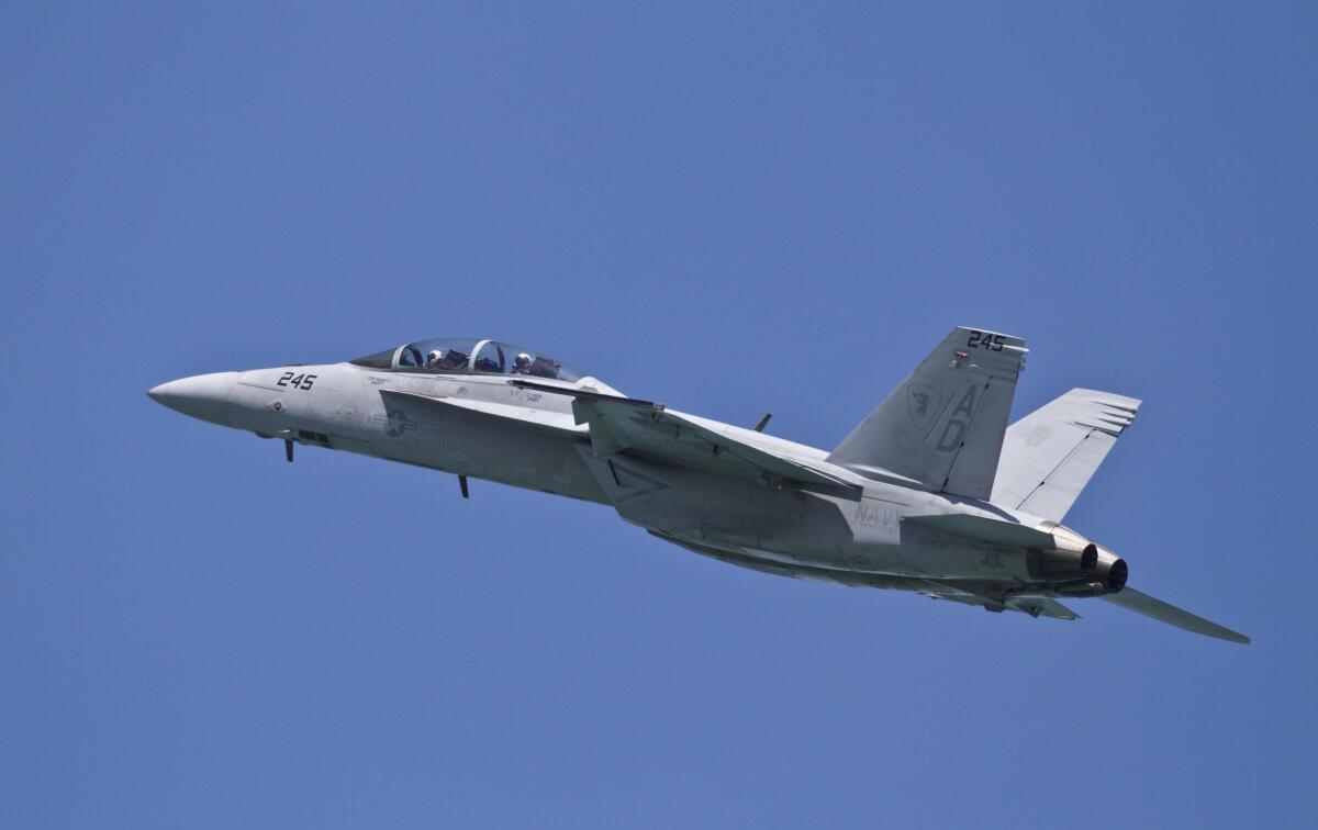 A U.S. Navy F-18 fighter jet flies over North Beach on the opening day of the Chicago Air and Water Show on Saturday, Aug. 18, 2012 in Chicago.