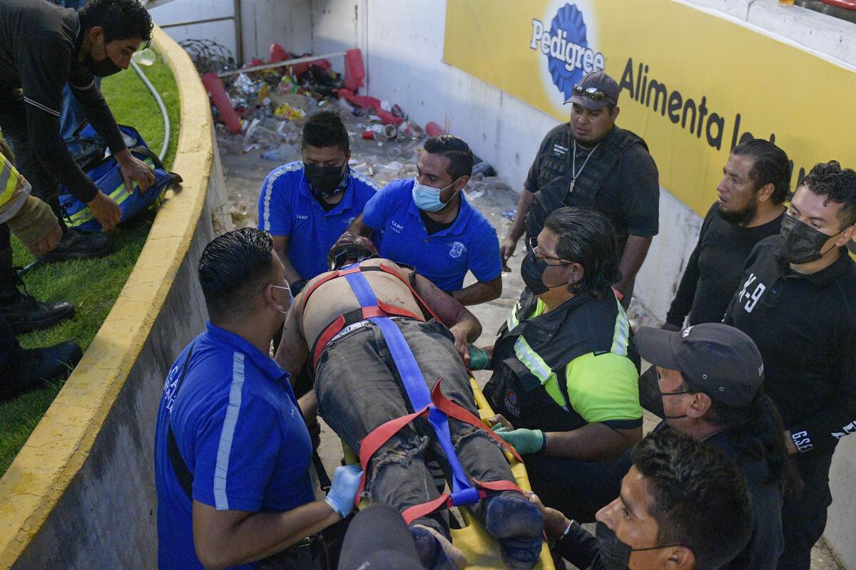 An injured man is evacuated from Corregidora Stadium Saturday in Queretaro, Mexico.