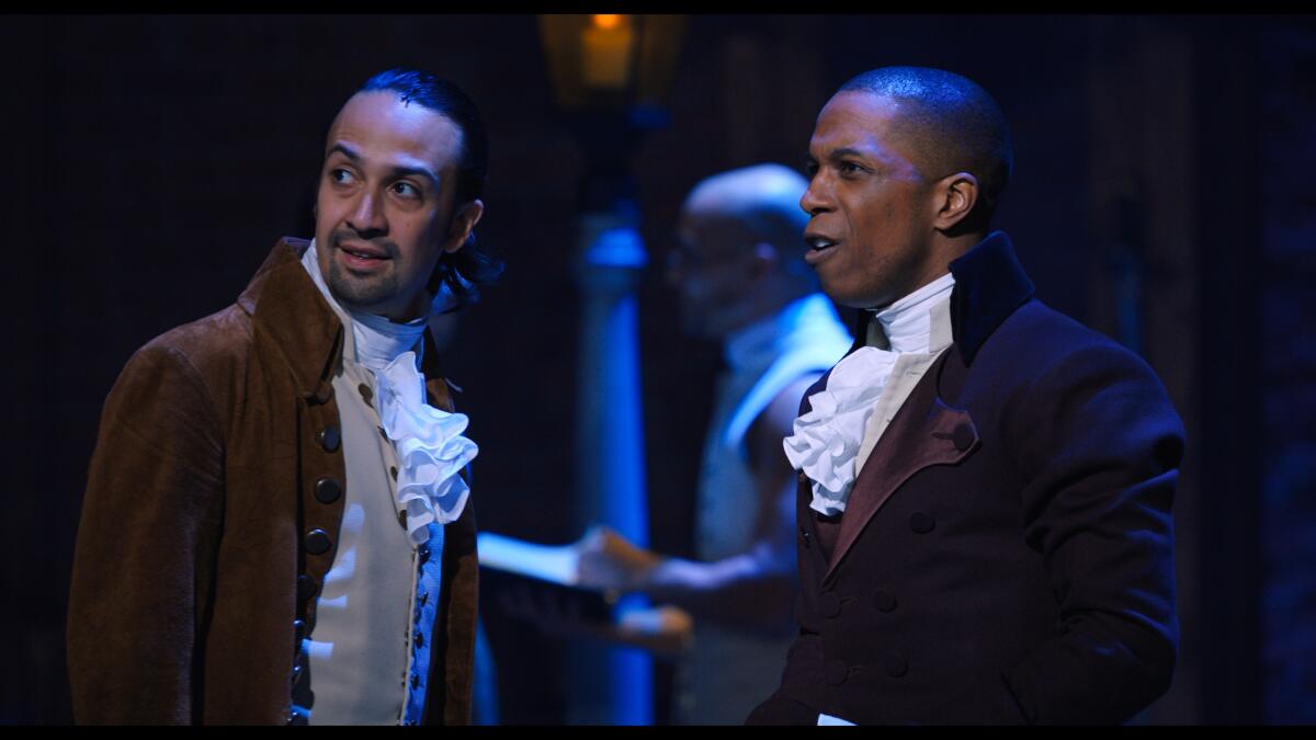 Lin-Manuel Miranda and Leslie Odom Jr. looking offstage in "Hamilton."