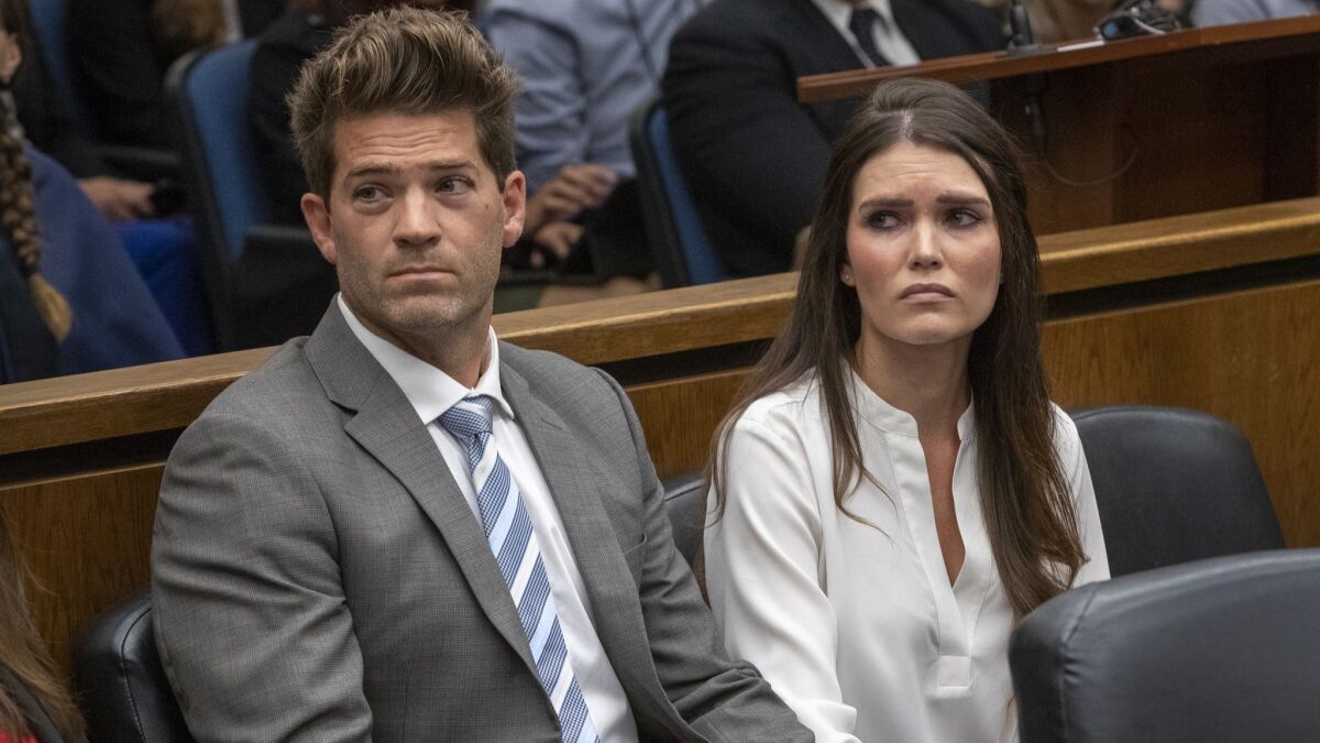 Dr. Grant Robicheaux, sitting with girlfriend Cerissa Riley in court Wednesday, was charged with drugging and raping five more women as prosecutors added felony kidnapping counts and increased bail for each of them to $1 million.
