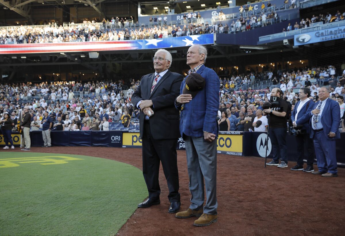 Ted Leitner (left) and Larry Lucchino listen to the national anthem at Petco Park on Thursday.