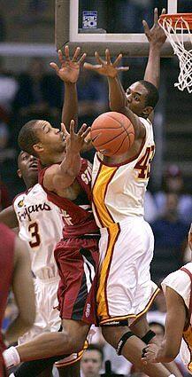 Stanford's Fred Washington has his shot blocked by USC's Kasey Cunningham, right and Lodrick Stewart.