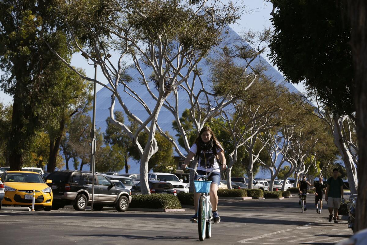 Students ride through a parking lot at Cal State Long Beach in this 2015 file photo.