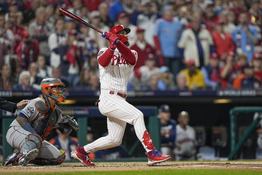 Philadelphia Phillies' Bryce Harper watches his two-run home run during the first inning in Game 3 of baseball's World Series between the Houston Astros and the Philadelphia Phillies on Tuesday, Nov. 1, 2022, in Philadelphia. (AP Photo/David J. Phillip)