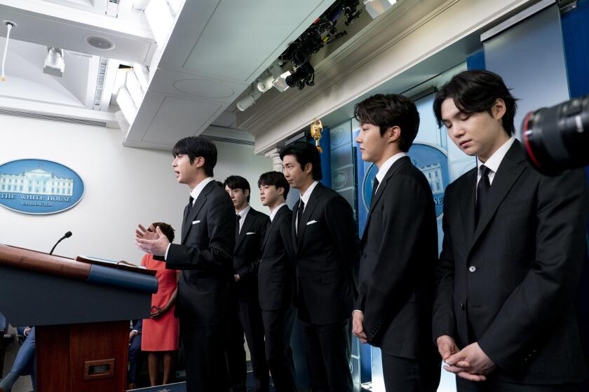 From left, Jin, accompanied by his K-pop supergroup BTS members Jungkook, Jimin, RM, J-Hope, and Suga, speaks during the daily briefing at the White House in Washington, Tuesday, May 31, 2022. (AP Photo/Andrew Harnik)