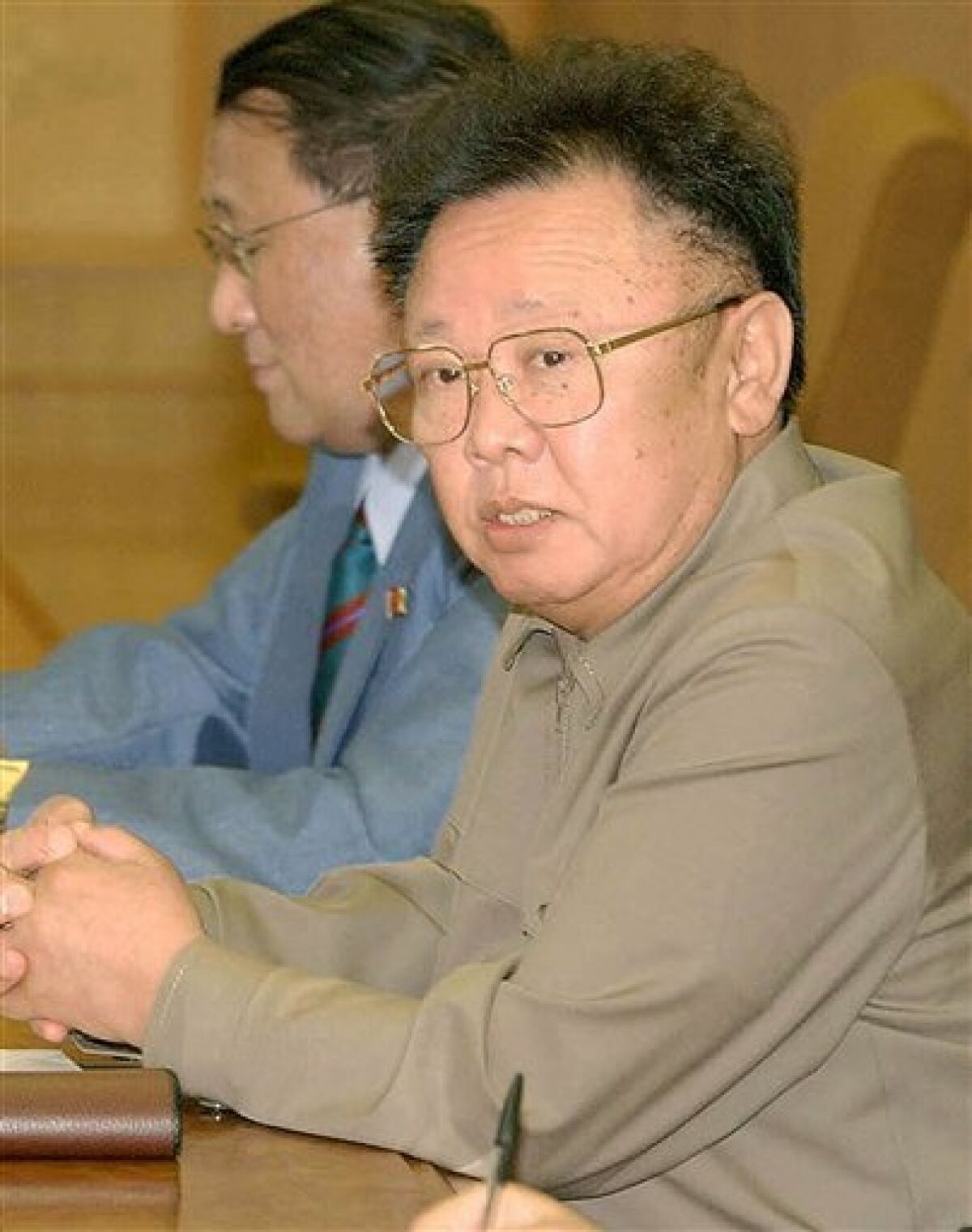 FILE- This file photo taken on Saturday, May 22, 2004, shows North Korean leader Kim Jong Il, foreground, accompanied by North Korean Vice Foreign Minister Kang Sok Ju, background, during a summit with Japanese Prime Minister Junichiro Koizumi in Pyongyang. North Korea told its diplomatic missions that Kim Jong Il's youngest son - who reportedly enjoys skiing and studied English, German and French at a Swiss school - will be the nation's next leader, a South Korean lawmaker and newspapers said Tuesday, June 2, 2009. The secretive communist state sent the message about the 26-year-old son, Jong Un, after the nation's May 25 nuclear test, which along with a series of missile tests has greatly raised tensions in the region, the Hankook Ilbo reported. (AP Photo/Japan Pool, File)