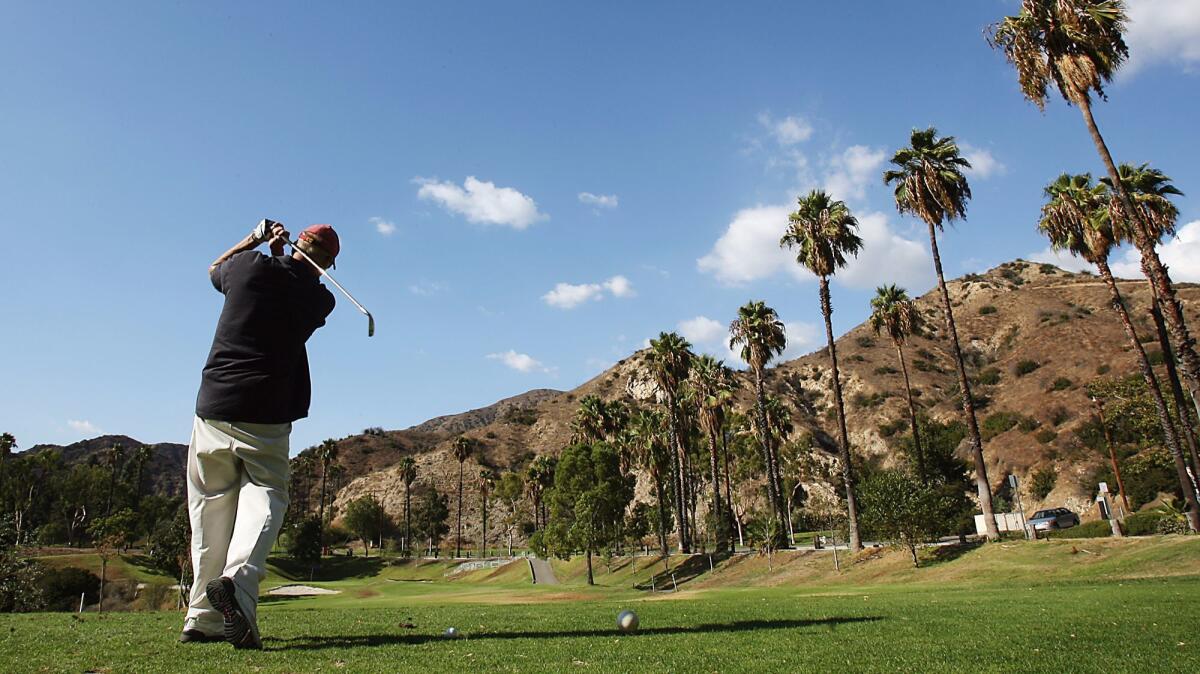 A golfer takes a swing while playing a round of golf at the DeBell Golf Course in 2007.