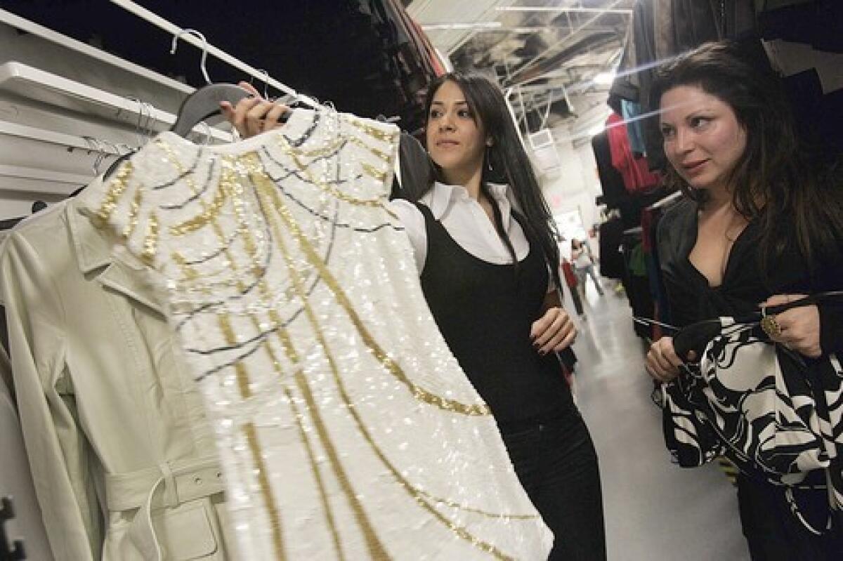 Pansy Toulou, left, shows the new M by Madonna line to Jessica Paster.