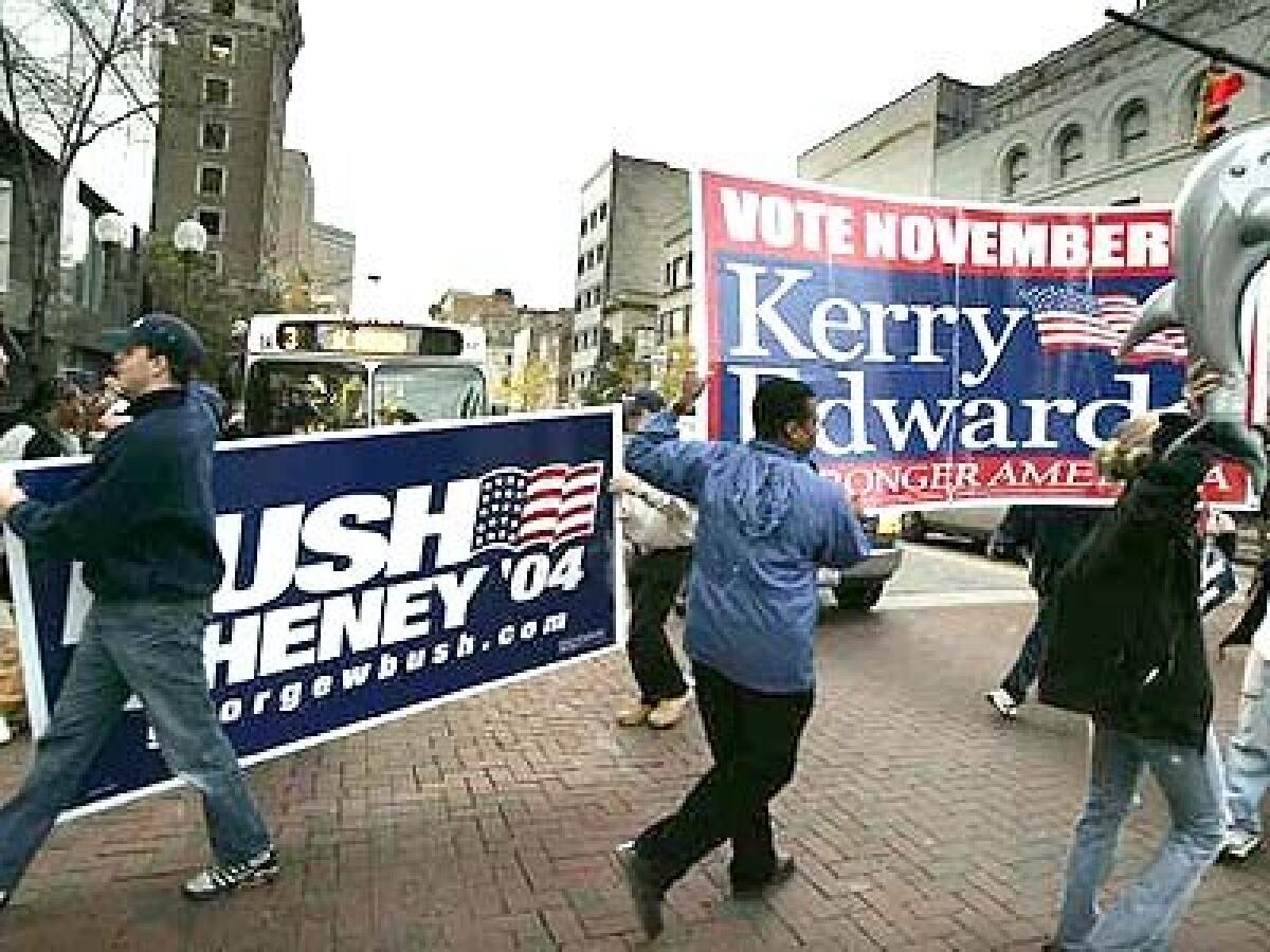 Competing campaigners parade through Columbus, Ohio. Their candidates hopscotched across battleground states, with President Bush vowing to keep America secure and Sen. John F. Kerry pledging a fresh start at home and in Iraq.