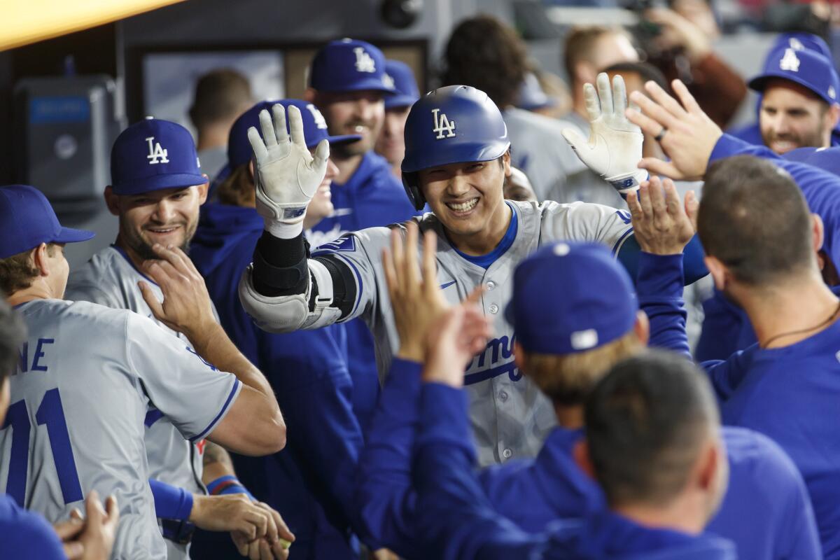 Dodgers star Shohei Ohtani celebrates after hitting a solo home run.