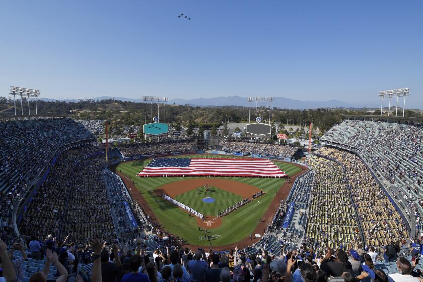 Four F-15 Eagles from the Air National Guard fly over Dodger Stadium during the national anthem.