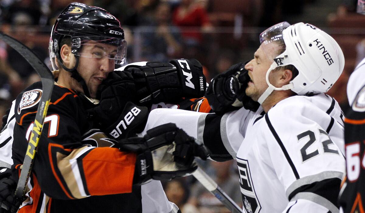 Ducks left wing Nick Ritchie, left, exchanges blows with Kings center Trevor Lewis, right, during the second period of a preseason game on Friday.