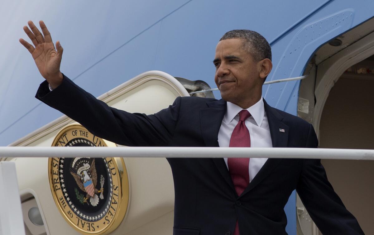 President Obama waves as he boards Air Force One for a trip to North Carolina.