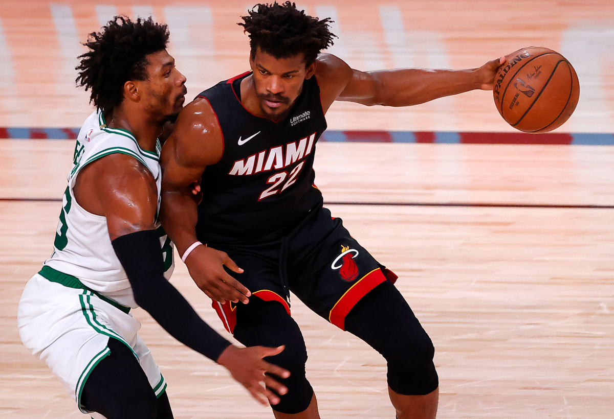 Celtics guard Marcus Smart, left, defends against Heat guard Jimmy Butler.