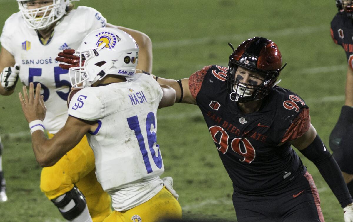 San Jose State’s Nick Nash is pressured by San Diego State’s Cameron Thomas.