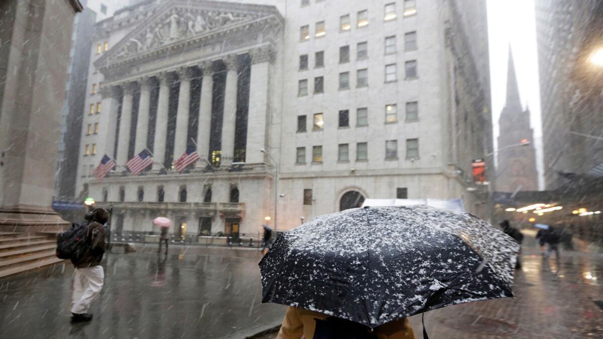 Snow falls in Manhattan outside the New York Stock Exchange.