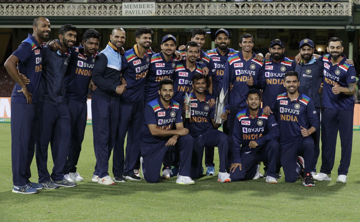 Members of the Indian team pose with the winners trophy at the end of the third T20 international cricket match between Australia and India at the Sydney Cricket Ground in Sydney, Australia, Tuesday, Dec. 8, 2020. Indian won the series 2-1. (AP Photo/Rick Rycroft)
