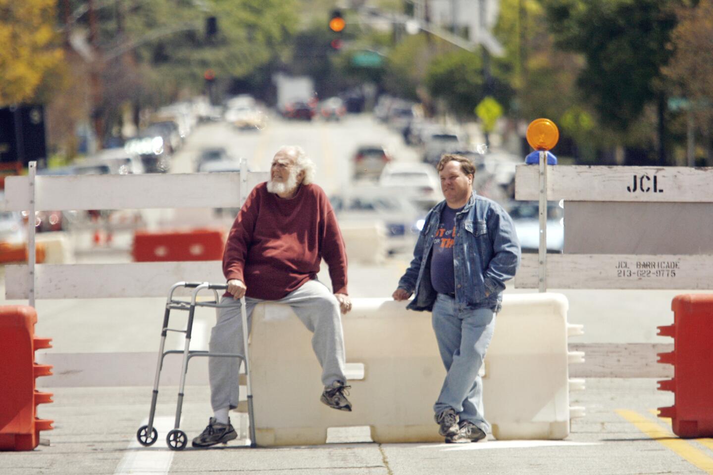 Charles Hodges, left, and Scott Stewart, watch participants in Burbank on Parade, which took place on Olive Ave. between Keystone St. and Lomita St. on Saturday, April 14, 2012.