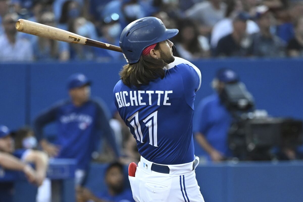 Toronto Blue Jays' Bo Bichette watches his two-run home run against the Cleveland Indians during the fourth inning of a baseball game Thursday, Aug. 5, 2021, in Toronto. (Jon Blacker/The Canadian Press via AP)