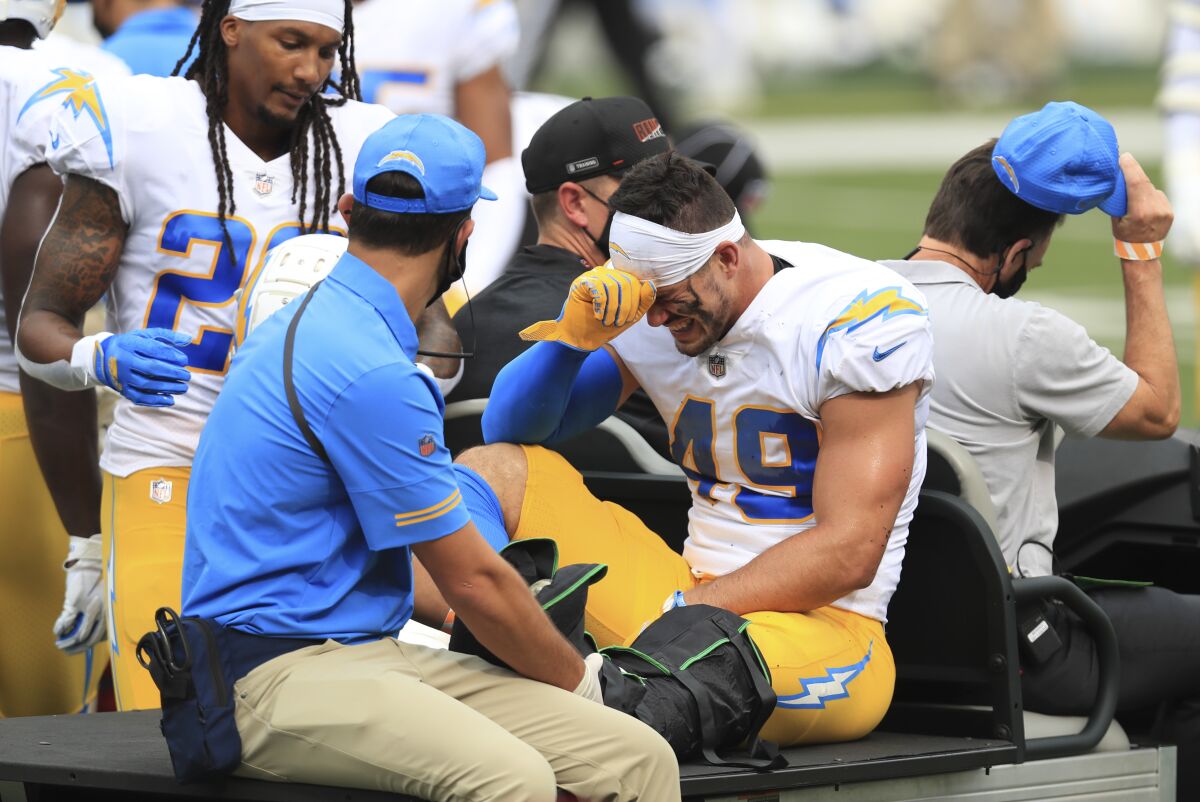 Chargers linebacker Drue Tranquill is carted off the field.