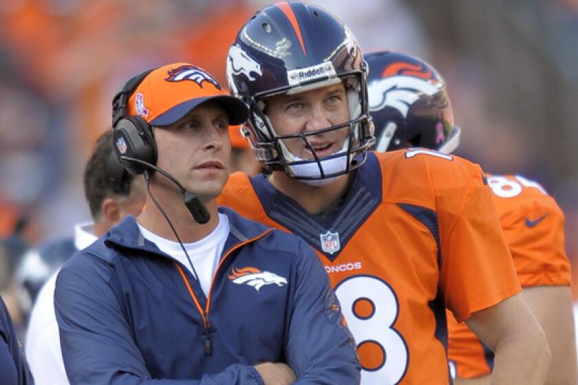 Denver Broncos offensive coordinator Adam Gase speaks with quarterback Peyton Manning during a game against the Jacksonville Jaguars in October. Gase is no longer interested in the Cleveland Browns' coaching job.