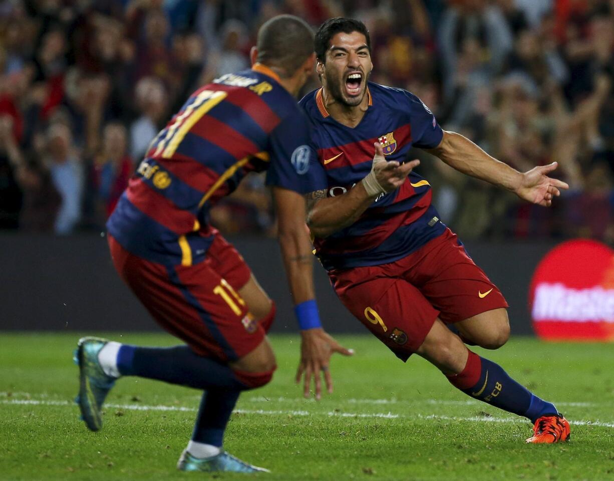 Barcelona's Luis Suarez celebrates after scoring a goal against Bayer Leverkusen during their Champions League group E soccer match at Camp Nou stadium in Barcelona