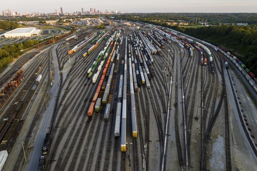 FILE - Freight train cars sit in a Norfolk Southern rail yard on Sept. 14, 2022, in Atlanta. Businesses are increasingly worried about the renewed threat of a railroad strike after two unions rejected their deals, and they want the White House and Congress to be ready to intervene. A coalition of 322 business groups sent a letter to President Joe Biden on Thursday, Oct. 27, 2022, urging him to make sure the deals he helped broker last month get approved because a railroad strike would have dire consequences for the economy. (AP Photo/Danny Karnik, File)