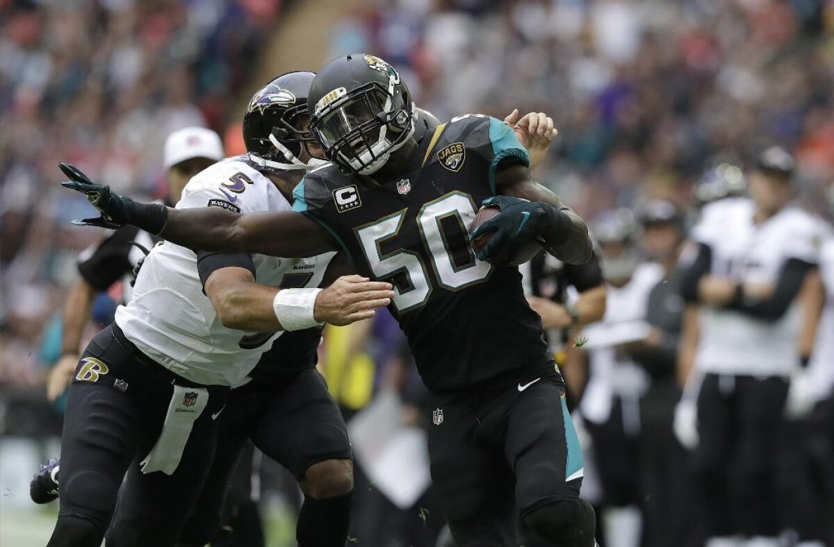 Jaguars outside linebacker Telvin Smith (50) returns a fumble by Ravens quarterback Joe Flacco (5) during the second half of a game at Wembley Stadium in London on Sept. 24.