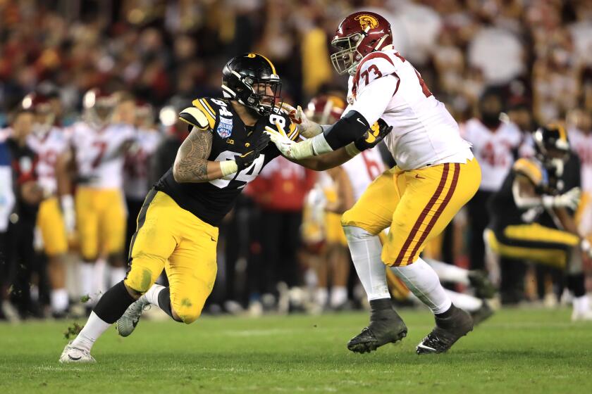 SAN DIEGO, CALIFORNIA - DECEMBER 27: Austin Jackson #73 of the USC Trojans blocks A.J. Epenesa #94 of the Iowa Hawkeyes during the second half of the San Diego County Credit Union Holiday Bowl at SDCCU Stadium on December 27, 2019 in San Diego, California. (Photo by Sean M. Haffey/Getty Images)