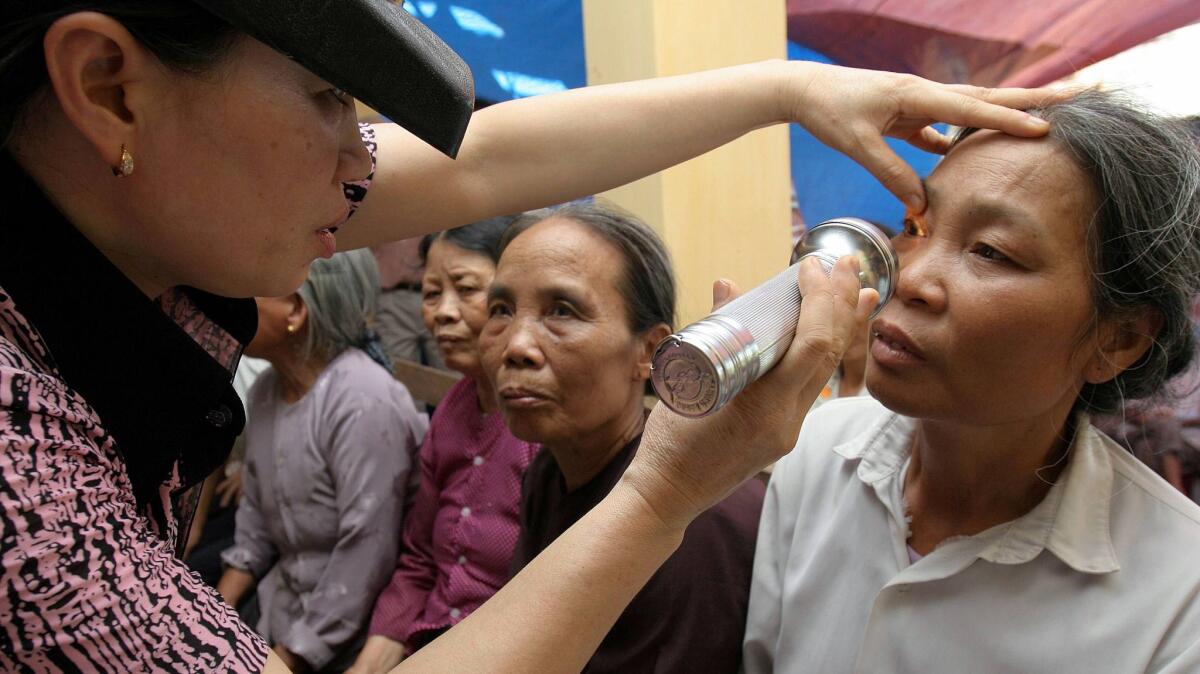 A woman receives an eye examination for trachoma at a medical center in Hiep Hoa, Vietnam, in 2005.