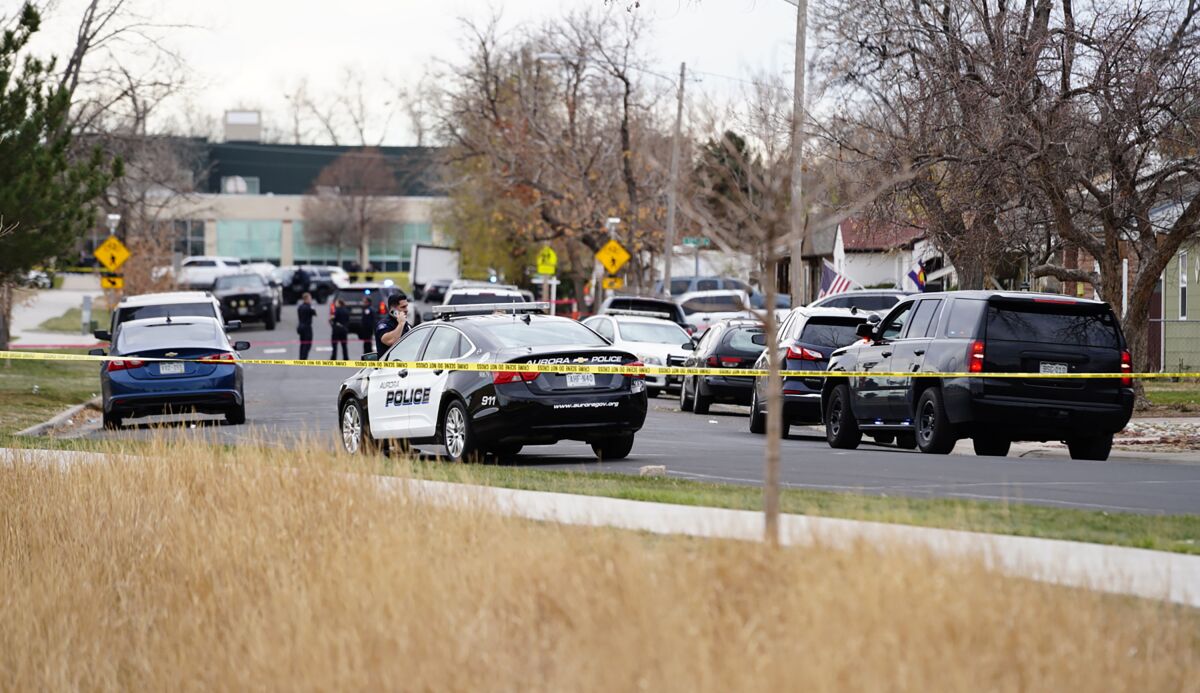 Law enforcement officials survey the scene of a shooting in which six teenagers were injured in a park, Monday, Nov. 15, 2021, in Aurora, Colo. (Philip B. Poston/Sentinel Colorado via AP)