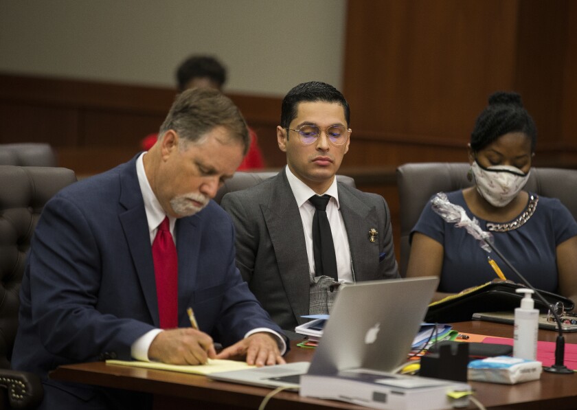 Attorney Michael Elliott and his client Victor Hugo Cuevas, a 26-year-old linked to a missing tiger named India, attend a bond revocation hearing on a separate murder charge at Fort Bend County Justice Center on Friday, May 14, 2021, in Richmond, Texas. (Godofredo A. Vásquez/Houston Chronicle via AP)
