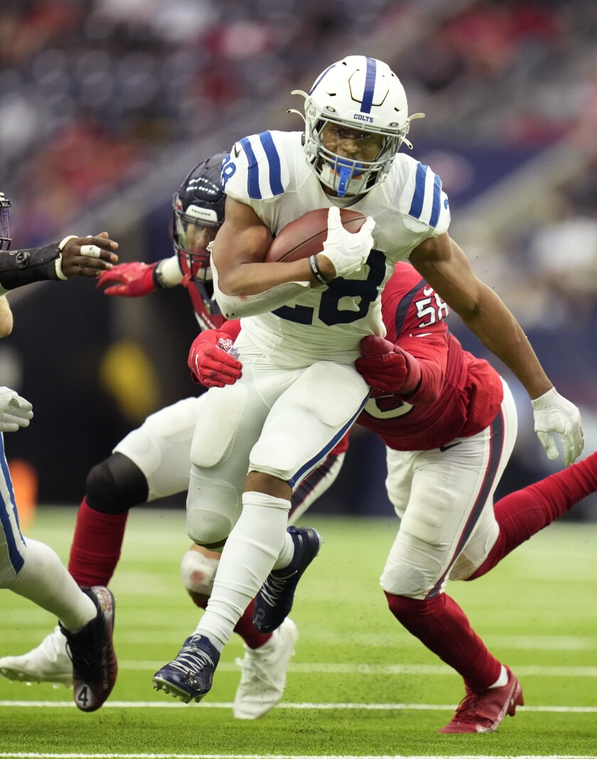 Indianapolis Colts running back Jonathan Taylor (28) is hit by Houston Texans middle linebacker Christian Kirksey (58) on a run during an NFL football game, Sunday, Dec. 5, 2021, in Houston. (AP Photo/Eric Christian Smith)