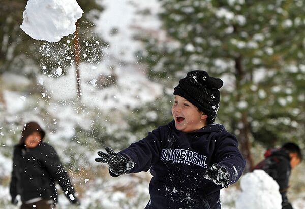Cameron Fuhrman, 9, of Fontana plays in freshly fallen snow in Wrightwood. See full story